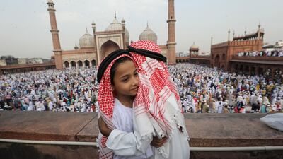 Indian Muslim children greet each offering prayers at Jama Masjid on the occasion of Eid-al-Fitr in New Delhi, India. EPA