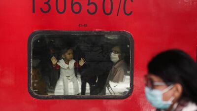 People wearing protective masks are seen at a railway station in Mumbai, India. REUTERS