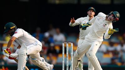 Australian wicketkeeper Tim Paine catches the ball with Pakistan's Yasir Shah batting . Getty