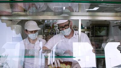 The father-son duo hard at work. Victor Besa / The National