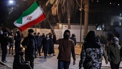 A protester waves an Iranian flag during a demonstration outside Baghdad's Green Zone, where the US embassy is located. AFP