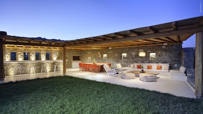 A grass-carpeted terrace at Residence MK04163 listed by Algean Property, in Elia, Mykonos