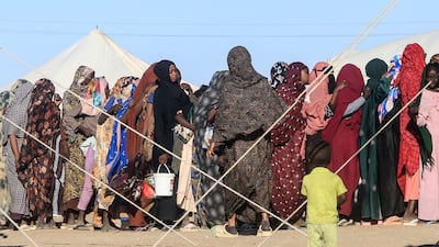 A queue for aid at Al Afad displacement camp in the town of Al Dabba, northern Sudan. Millions have been forced to flee their homes in the country. AFP