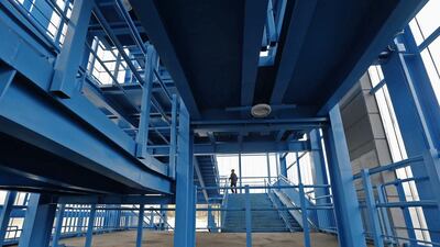 A person walks at an overhead crossing close to the track used by the Allegro high-speed train route in Leningrad. Alexander Demianchuk / Reuters