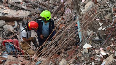 Rescue workers search for survivors in the rubble of a collapsed five-storey apartment building in Mahad, about 170 kilometres from India's financial capital of Mumbai in western Maharashtra state. AFP