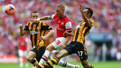 Kieran Gibbs of Arsenal takes on James Chester, left, and Ahmed Elmohamady of Hull City, right, during the FA Cup final between Arsenal and Hull City at Wembley Stadium on May 17, 2014 in London, England. Paul Gilham/Getty Images