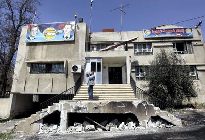 A cameraman films the destroyed Revolution Youth Union branch, affiliated to the ruling Syrian Baath Party which was was destroyed by Syrian anti-government protesters, in the southern city of Deraa, Syria, Monday March 21, 2011. AP