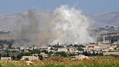 Smoke billows above buildings during shelling by government and allied forces, in the town of Hbeit in the southern countryside of the rebel-held Idlib province. AFP