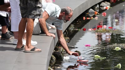 A family member of one of the 185 victims releases a toy boat into the Avon River during the national memorial service. Getty Images