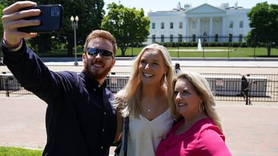 Tourists pose for a selfie in Lafayette Square after it was reopened to the public. The park offers a view of the White House. Reuters