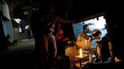 A tea seller prepares tea for laborers in the old city area of New Delhi. Bernat Armangue / AP Photo