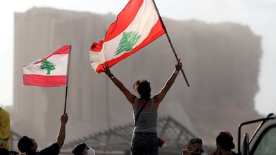 Demonstrators wave Lebanese flags during protests near the site of the blast that killed more than 220 people and injured thousands more. Reuters