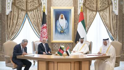 Sheikh Mohamed and Mr Ghani witness the signing of an agreement on mining, energy, education and sports between the UAE and Afghanistan. Seen signing are Dr Anwar Gargash, Minister of State for Foreign Affairs, right, and Humayun Qayoumi, Minister of Finance of Afghanistan, left, at the Presidential Palace.