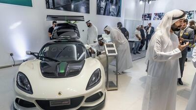 Visitors mingle among the models on display.