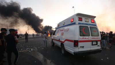 An ambulance arrives at a demonstration in Baghdad. AFP