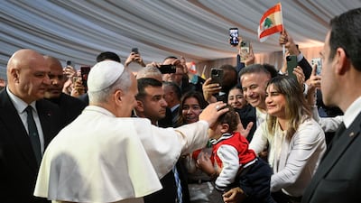 Pope Leo blesses a child during a warm welcome as he arrives in the country at Beirut International Airport. EPA