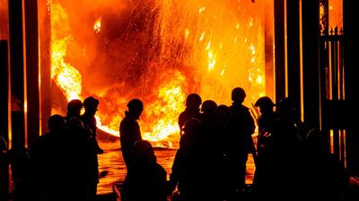 Firefighters douse a fire at the Attorney General's office in Jakarta. AFP