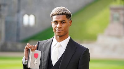 Footballer Marcus Rashford poses after receiving his MBE at England’s Windsor Castle. Reuters