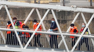 Migrants disembark after arriving at Dover harbour, in Dover, Britain August 12, 2020. REUTERS/Matthew Childs