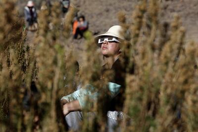 A woman watches a solar eclipse at Incahuasi, Chile. Reuters