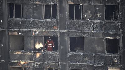 A member of the emergency services works inside the Grenfell apartment tower block in North Kensington, London
