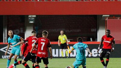 Lionel Messi, second right, score his side's fourth goal against Mallorca. AP Photo