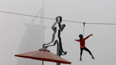 A young girl is at the Wire World Adventure Park during a cloudy and dusty day at Kite Beach in Dubai. Pawan Singh / The National