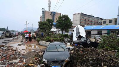 Cars are stuck on a muddy road after severe flooding and landslide hit Gongyi city.