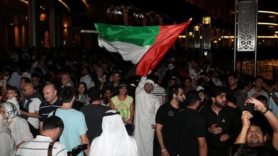People celebrate after Dubai was named the host city for Expo 2020 at the Dubai fountain in Dubai. Christopher Pike / The National