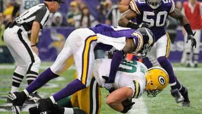 Husain Abdullah of the Minnesota Vikings gets taken for a ride into the end zone by John Kuhn of the Green Bay Packers.