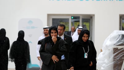 Attendees walk through the rain. Chris Whiteoak / The National