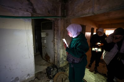 A woman looks round the liberated Sednaya prison near Damascus, which was known as 'the human slaughterhouse' under Bashar Al Assad’s rule. Reuters