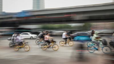 People riding bicycles in Chaoyang district, Beijing. China's capital city announced three rounds of mass testing after a Covid-19 outbreak at a bar after the city eased restrictions. EPA