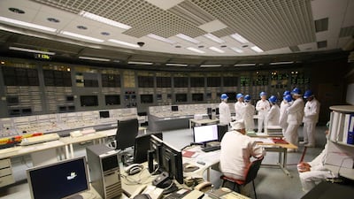 People stand in the monitoring room during a guided tour inside the inoperative Ignalina nuclear power plant.