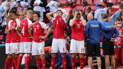 Distraught Denmark players look away while their teammate Christian Eriksen receives medical treatment after collapsing during the Euro 2020 match against Finland in Copenhagen on June 12.