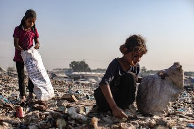 Palestinian children pick through rubbish at a landfill near the Khan Younis refugee camp, in the southern Gaza Strip, on Monday. EPA