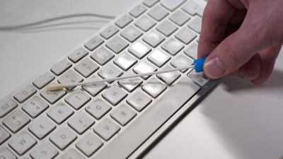 News Editor Michael Jabri-Pickett collects swab samples from around the office as part of a survey of germ levels found on common workplace surfaces. Brian Kerrigan / The National