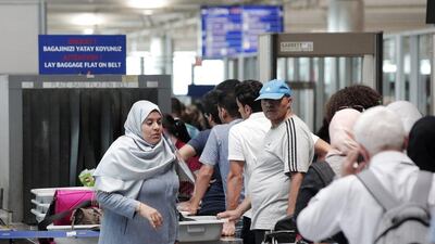 Above, passengers wait for security checks as they enter Istanbul's Ataturk airport. Lefteris Pitarakis / AP Photo