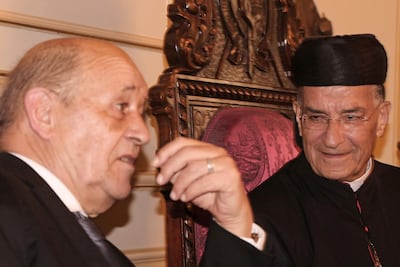 Lebanon's Christian Maronite patriarch Beshara Rai (R) meets with France's Foreign Minister Jean-Yves Le Drian in Bekerke north of Beirut on July 23 AFP