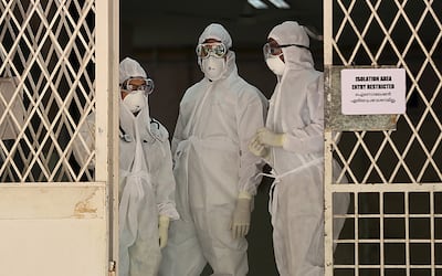 Medical staff wearing full protective suits in Kochi, Kerala, after an outbreak of the virus in 2019. EPA
