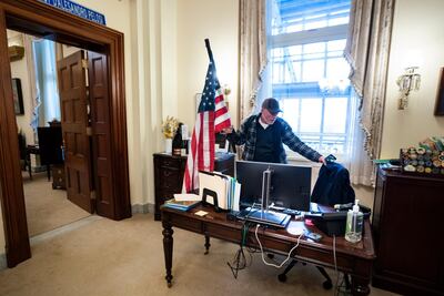 epa08926303 Richard Bigo Barnett, a supporter of US President Donald J. Trump and his baseless claims of voter fraud, takes a seat in the office of Speaker of the House Nancy Pelosi after breaching Capitol security during a protest against Congress certifying Joe Biden as the next president in Washington, DC, USA, 06 January, 2020 (issued 08 January 2020). On 08 January Assistant House Speaker Katherine Clarke said the House will move to impeach President Trump if the Vice President and Cabinet do not remove him on their own. EPA/JIM LO SCALZO
