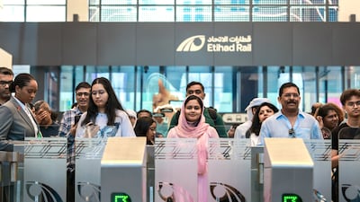 Passengers wait to scan their tickets before leaving the Mohamed bin Zayed City station in Abu Dhabi