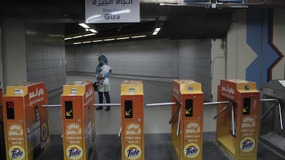 A woman carries her child at Al Shohadaa (Martyrs) metro station.