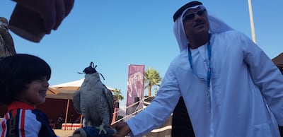 Abudullah Hammadi and pet falcon Hirjeel at the 2019 Abu Dhabi F1 Heritage Village. Photo: Saeed Saeed / The National