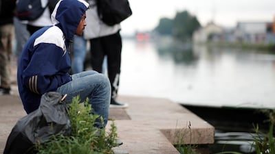 Migrants gather by the canal as French police evacuate hundreds of migrants living in makeshift camps in Paris, France. Benoit Tessier / Reuters