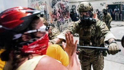 Federal officers disperse Black Lives Matter protesters in Portland. AP