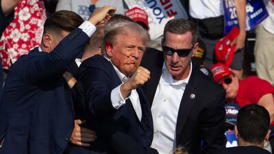 US Republican candidate Donald Trump is led off stage by Secret Service agents following an assassination attempt in July. AFP