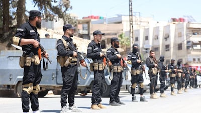 Syrian security troops in a street in the mostly Druze and Christian suburb of Jaramana, Damascus, after a deadly attack by armed groups from neighbouring areas. AFP