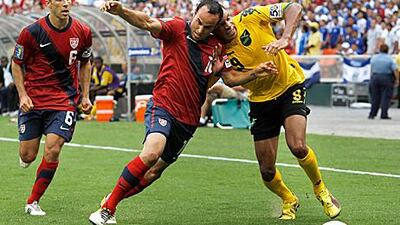 The US forward Landon Donovan, centre, challenges Jamaica's Ryan Johnson during their Concacaf Gold Cup semi-final. The US won 2-0.