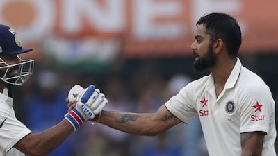 Indian batsman Ajinkya Rahane congratulates team captain Virat Kohli, right, for scoring a century on Day 1. Rafiq Maqbool / AP Photo